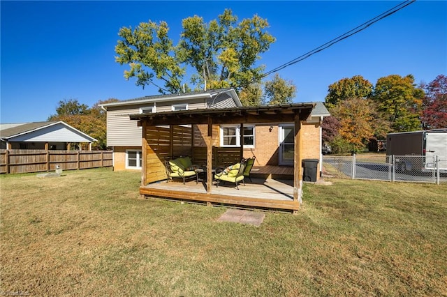 back of house featuring a deck and a lawn