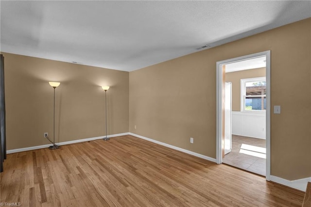 spare room with light hardwood / wood-style flooring