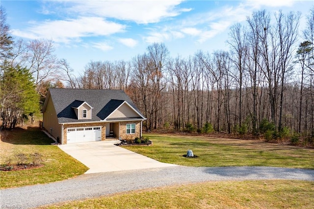 view of front facade with a front yard, a garage, a forest view, and driveway