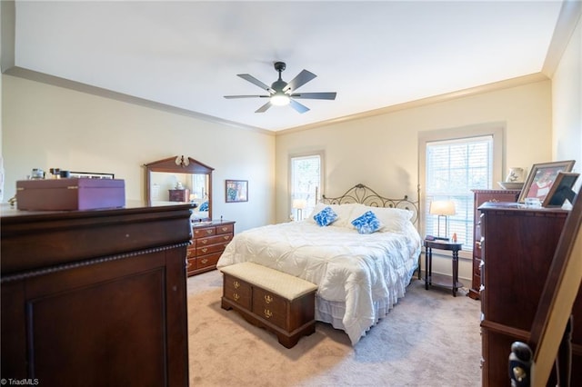 bedroom featuring multiple windows, light colored carpet, and crown molding