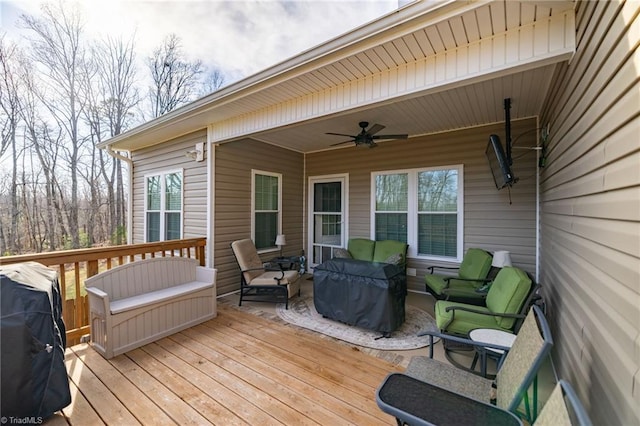 deck featuring grilling area, an outdoor hangout area, and ceiling fan