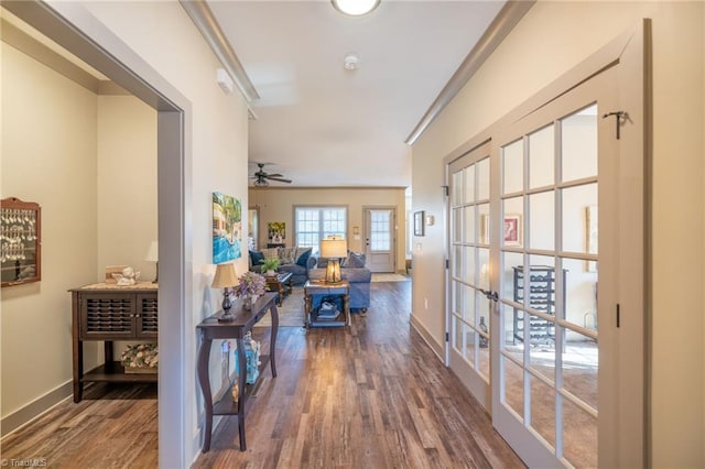 hall with french doors, baseboards, and wood finished floors