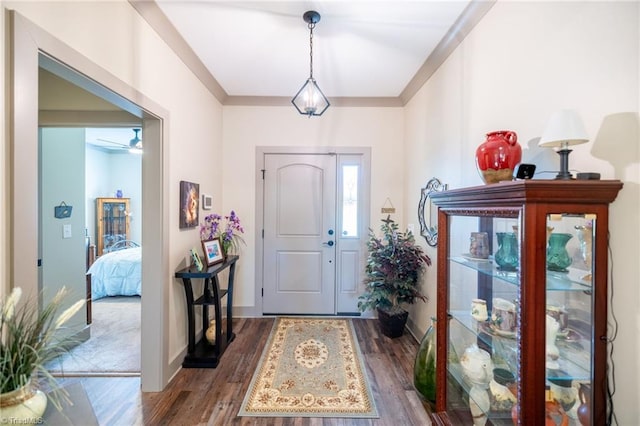 entrance foyer featuring baseboards, wood finished floors, and a ceiling fan