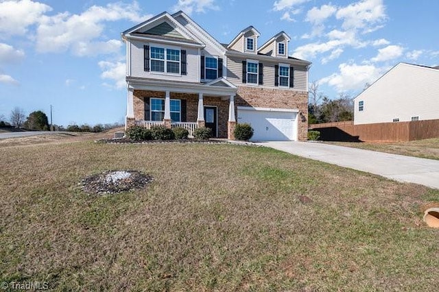 craftsman house featuring a front lawn, covered porch, and a garage