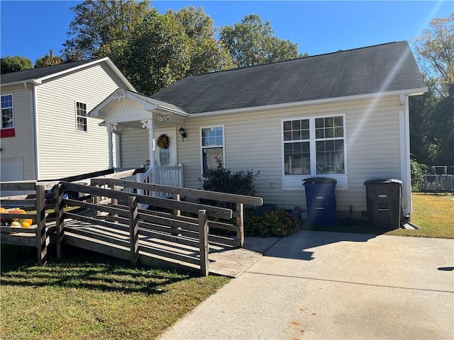 view of front facade with a deck and a front lawn