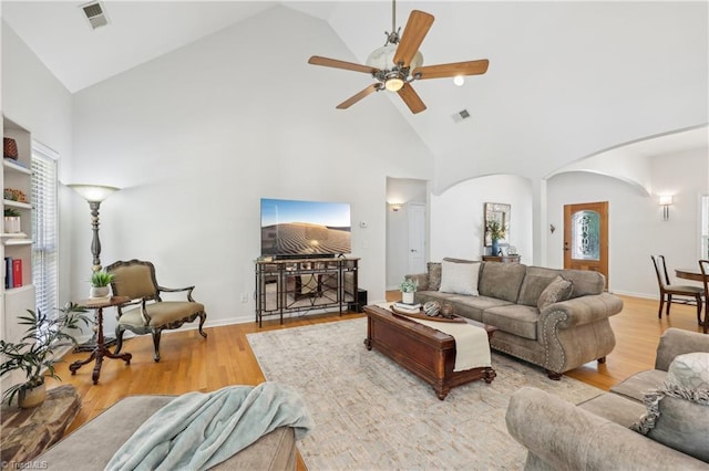 449 Wallburg High Point Rd, Winston-Salem, NC 27107 - living area with high vaulted ceiling, arched walkways, ceiling fan, and wood finished floors