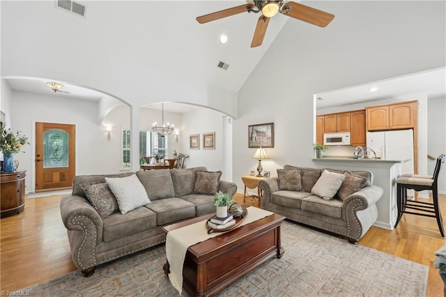 449 Wallburg High Point Rd, Winston-Salem, NC 27107 - living room with arched walkways, high vaulted ceiling, light wood finished floors, a chandelier, and a ceiling fan