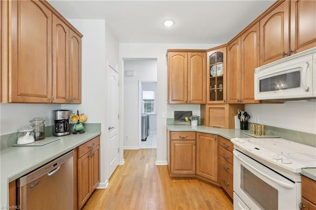 449 Wallburg High Point Rd, Winston-Salem, NC 27107 - kitchen featuring white appliances, light wood-style flooring, light countertops, glass insert cabinets, and baseboards