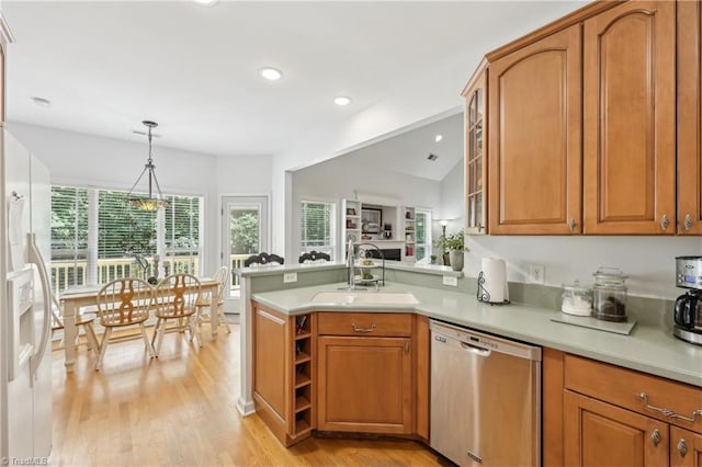 449 Wallburg High Point Rd, Winston-Salem, NC 27107 - kitchen with stainless steel dishwasher, a sink, brown cabinetry, a peninsula, and light wood-style floors