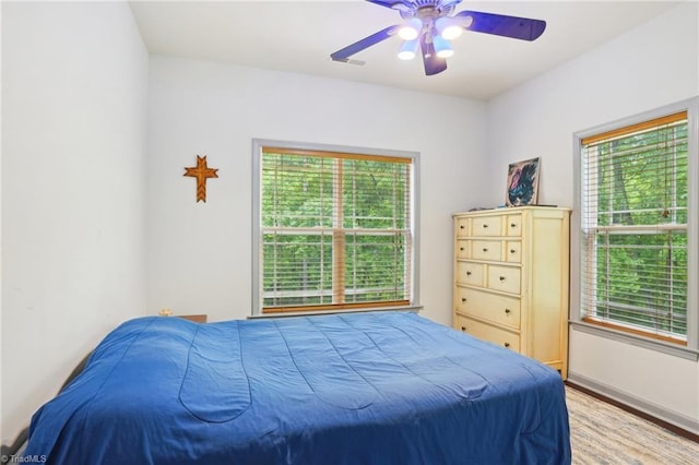 449 Wallburg High Point Rd, Winston-Salem, NC 27107 - bedroom featuring multiple windows, light wood finished floors, and ceiling fan