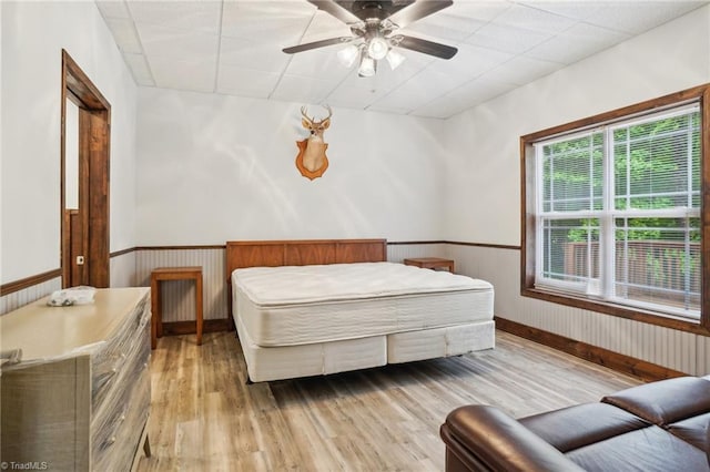 449 Wallburg High Point Rd, Winston-Salem, NC 27107 - bedroom with light wood finished floors, a wainscoted wall, ceiling fan, and baseboards