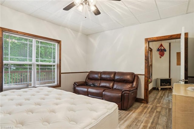 449 Wallburg High Point Rd, Winston-Salem, NC 27107 - bedroom featuring wood finished floors, a wainscoted wall, a drop ceiling, and ceiling fan