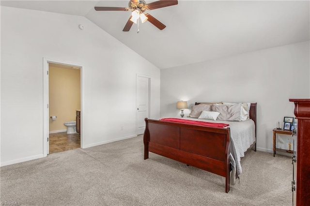 bedroom with carpet, a ceiling fan, ensuite bathroom, baseboards, and vaulted ceiling
