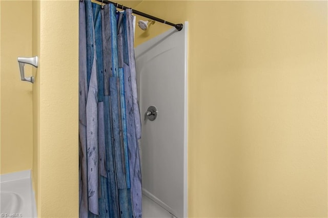 bathroom featuring curtained shower and a bathtub