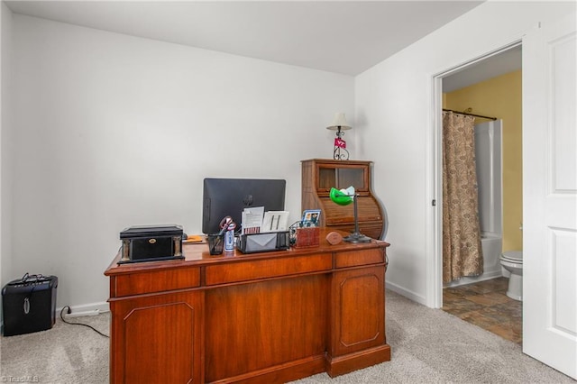 home office with baseboards and light carpet