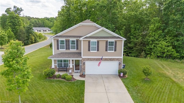 view of front of property featuring an attached garage, driveway, a front lawn, and stone siding