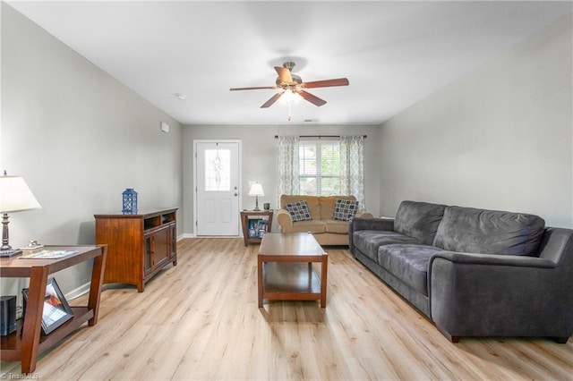 living room with baseboards, light wood-style floors, and ceiling fan
