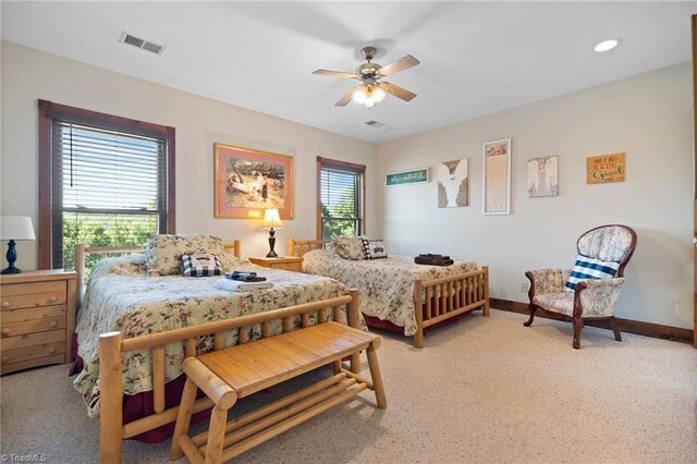 bedroom featuring light carpet and ceiling fan