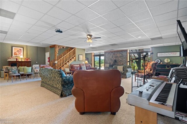 living room featuring a paneled ceiling and ceiling fan