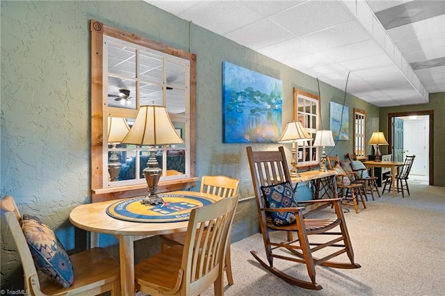 dining room featuring a drop ceiling and ceiling fan