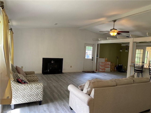 living room featuring vaulted ceiling with beams, hardwood / wood-style floors, and ceiling fan