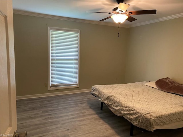 bedroom with ceiling fan, ornamental molding, and hardwood / wood-style floors