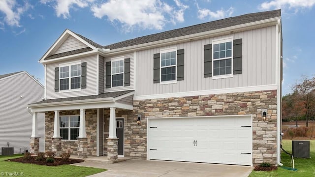 craftsman-style house with a garage, a front yard, central air condition unit, and a porch