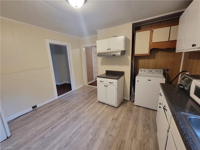 kitchen featuring sink, crown molding, light hardwood / wood-style floors, white cabinets, and washer / dryer