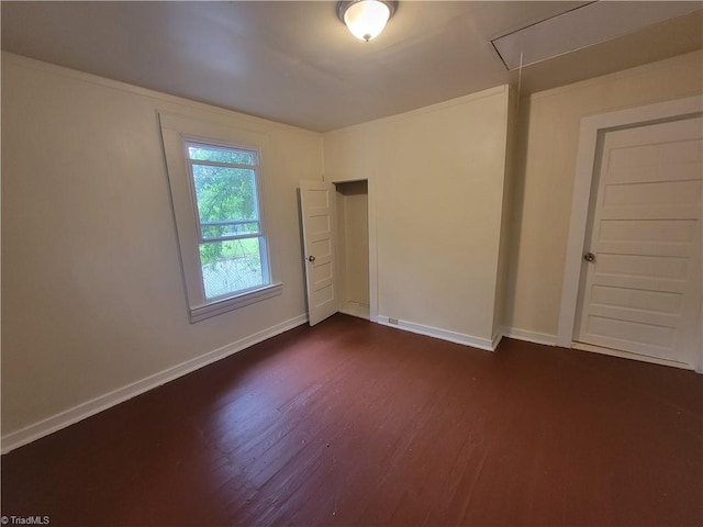 empty room featuring dark hardwood / wood-style flooring