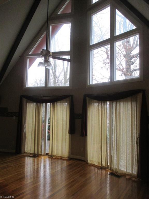 unfurnished living room featuring ceiling fan, high vaulted ceiling, and hardwood / wood-style flooring