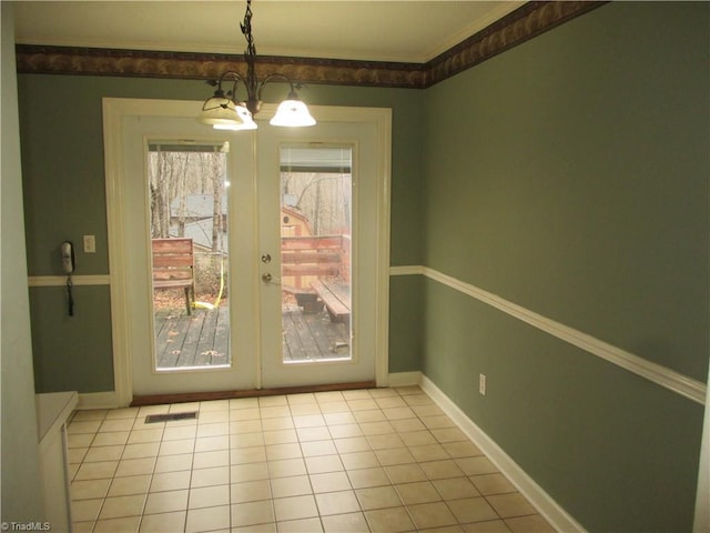 doorway to outside with french doors, light tile patterned flooring, and an inviting chandelier