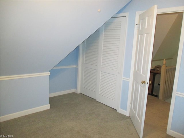 bonus room with light carpet and lofted ceiling