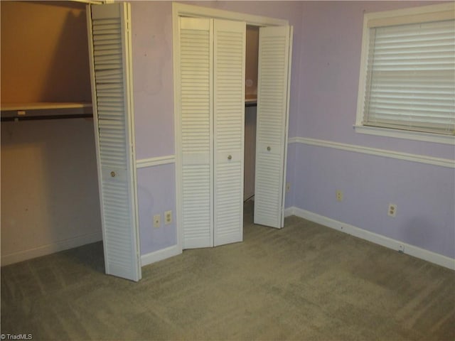 unfurnished bedroom featuring dark colored carpet