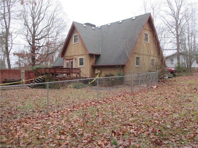 back of house with a wooden deck