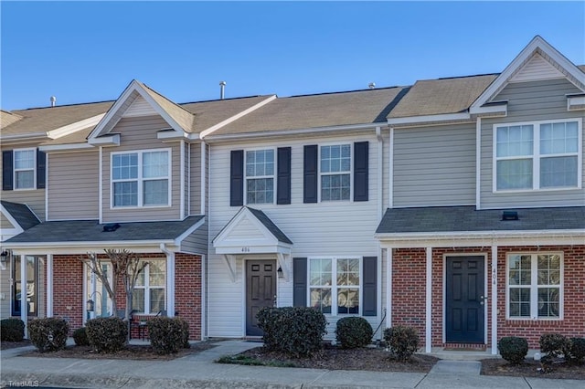 townhome / multi-family property featuring brick siding