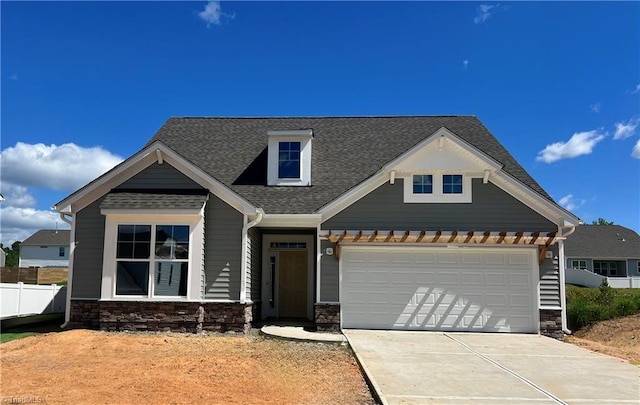 1239 Guyton Dr, Winston-Salem, NC 27127 - craftsman-style house featuring concrete driveway, stone siding, a shingled roof, and a garage
