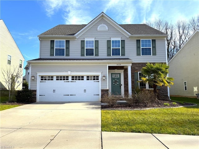 view of front of property with a front yard and a garage