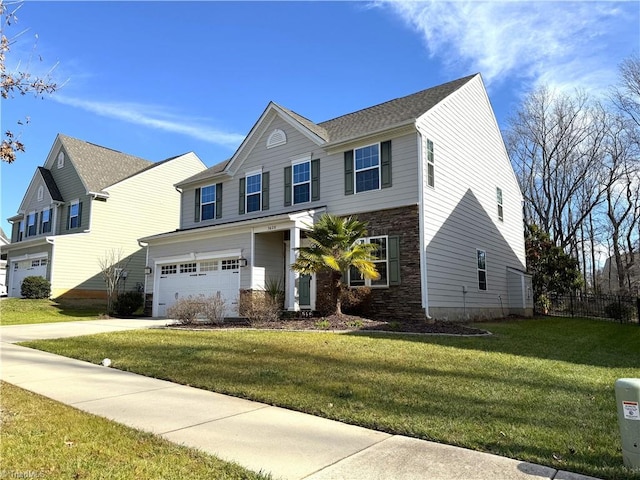 view of front of property featuring a garage and a front yard