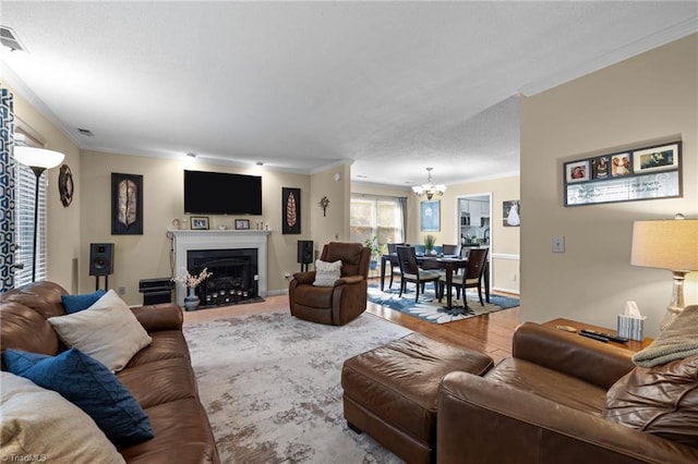 3100 Coachmans Way, Durham, NC 27705 - living area featuring a chandelier, a fireplace with flush hearth, wood finished floors, and ornamental molding