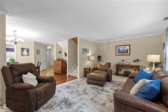 3100 Coachmans Way, Durham, NC 27705 - living room with crown molding, stairs, light wood-style floors, baseboards, and a notable chandelier