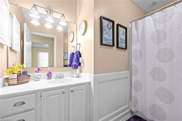 3100 Coachmans Way, Durham, NC 27705 - bathroom featuring wainscoting, a shower with curtain, and vanity