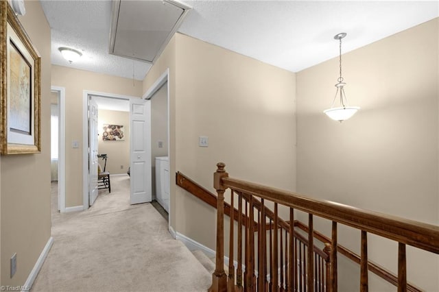 3100 Coachmans Way, Durham, NC 27705 - hall featuring attic access, light carpet, a textured ceiling, baseboards, and an upstairs landing