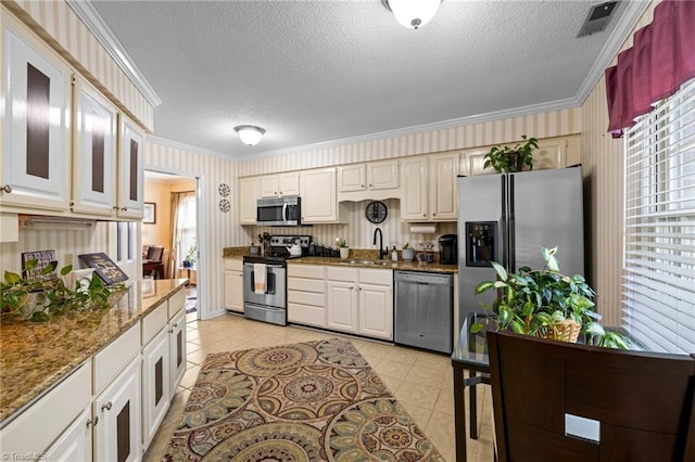 3100 Coachmans Way, Durham, NC 27705 - kitchen with crown molding, stainless steel appliances, a textured ceiling, and a sink