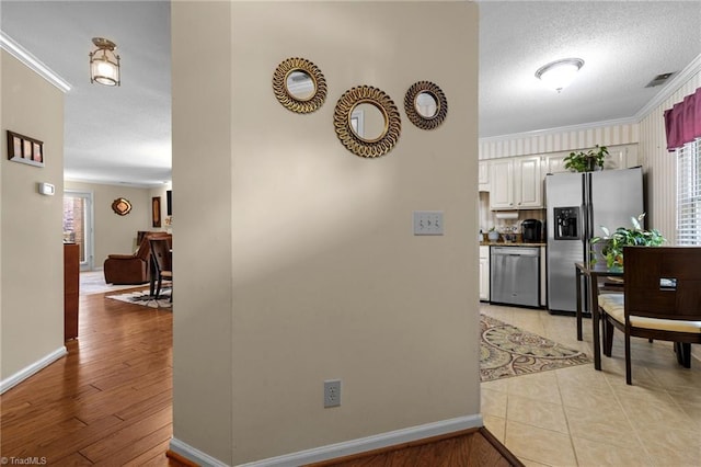 3100 Coachmans Way, Durham, NC 27705 - hall featuring a textured ceiling, crown molding, baseboards, and visible vents