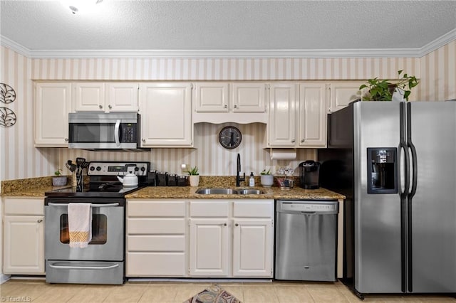 3100 Coachmans Way, Durham, NC 27705 - kitchen with wallpapered walls, ornamental molding, a sink, and appliances with stainless steel finishes