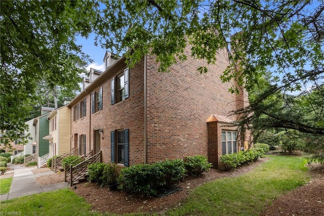 3100 Coachmans Way, Durham, NC 27705 - view of home's exterior featuring brick siding and a lawn