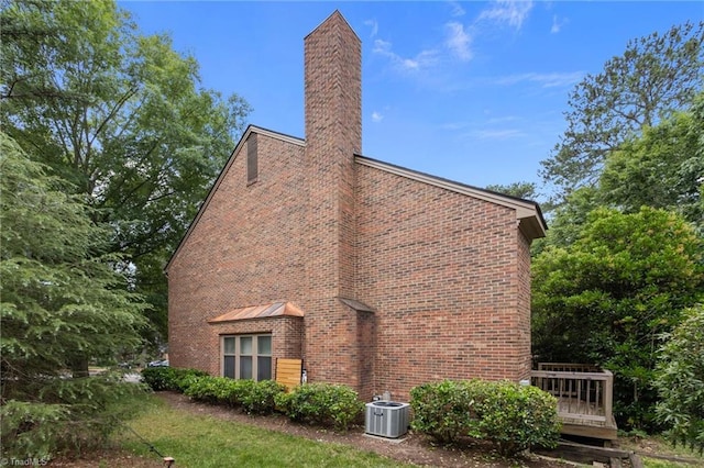 3100 Coachmans Way, Durham, NC 27705 - view of home's exterior with a chimney and brick siding