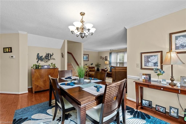 3100 Coachmans Way, Durham, NC 27705 - dining room with baseboards, crown molding, wood finished floors, and a chandelier