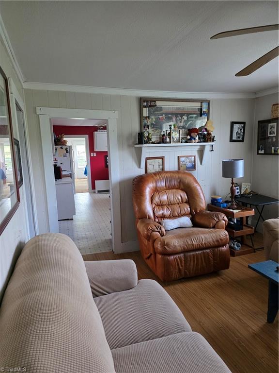 4793 Cheek Mountain Rd, Laurel Springs, NC 28644 - living area with wood finished floors, ornamental molding, and a ceiling fan