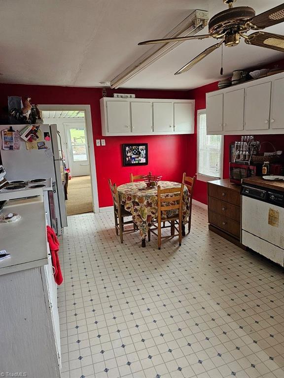 4793 Cheek Mountain Rd, Laurel Springs, NC 28644 - kitchen with white dishwasher, a ceiling fan, white cabinets, and light flooring